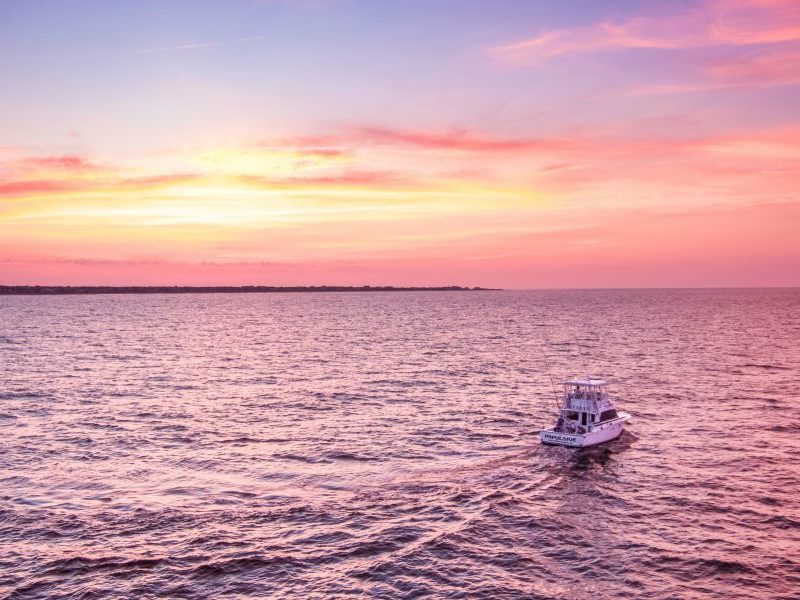 Aerial View of Impulsive Charters Boat in the Water near Bald Head Island at Sunset-fit(1000,600).2fa0574b