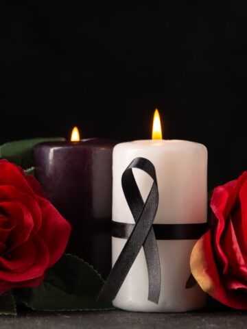 front-view-pair-candles-red-flowers-black-scaled